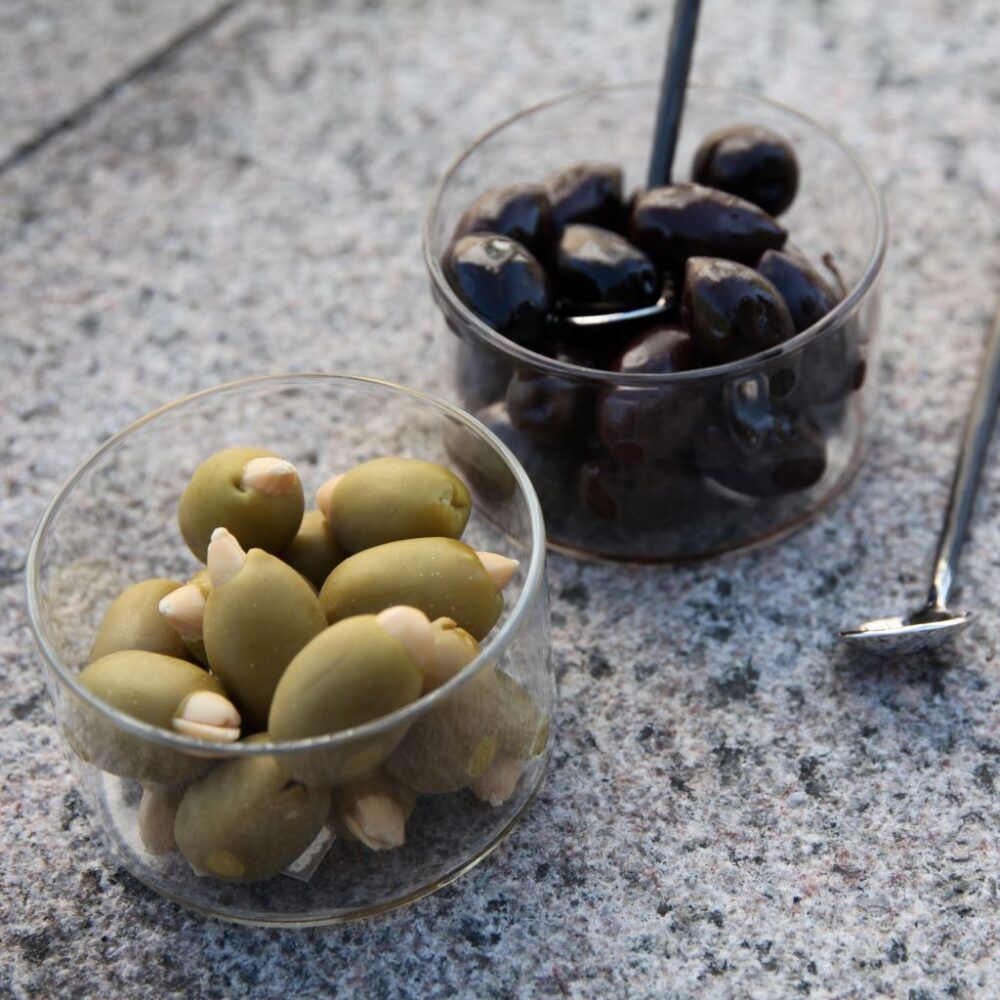 two-bowls-in-a-glass-with-olives-and-olive-spoon-orskov